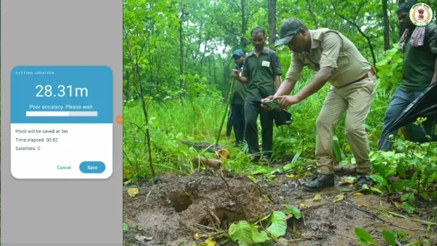 Foot officers taking a picture of elephant marks