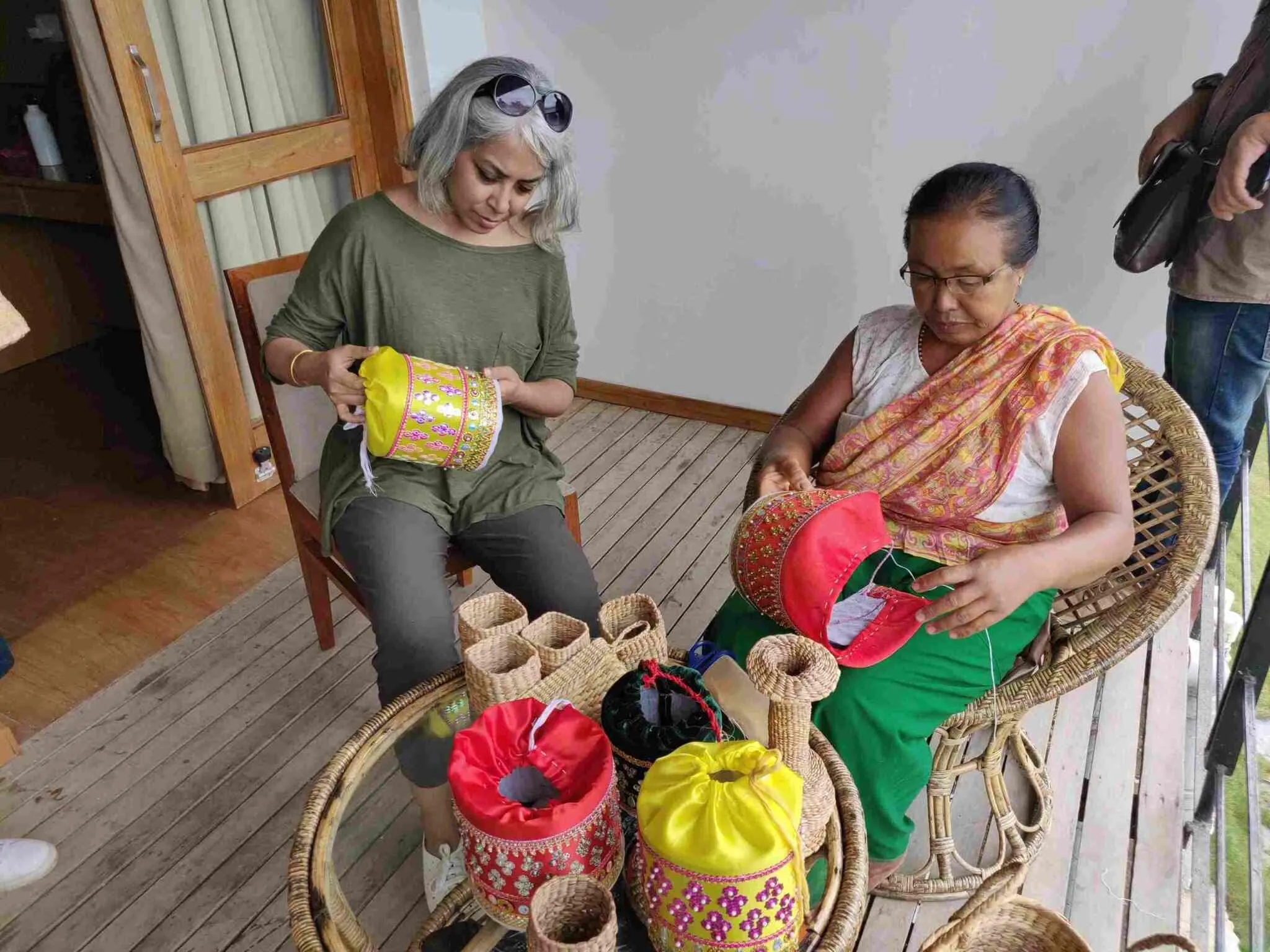 people learning weaving from the villagers.