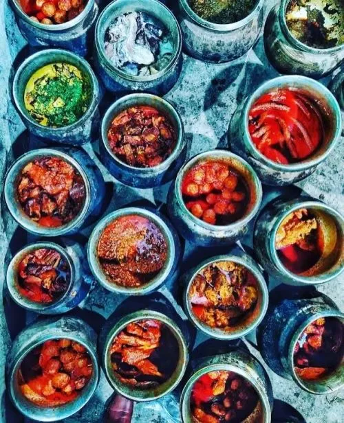 Traditional Wazwan dishes simmering in authentic degis.