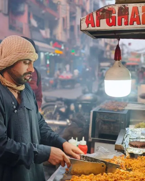 A vendor preparing chicken filling for Afghani Samosa in Shaheen Bagh.