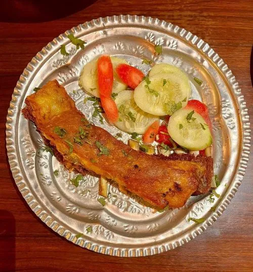 Tabakh Maaz—crispy, golden-brown lamb ribs slow-cooked in aromatic spices and ghee.