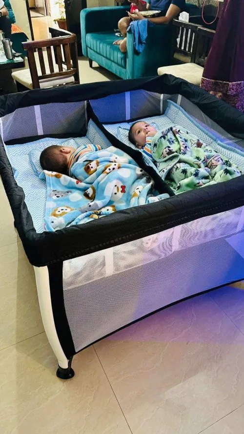 The twin bassinet features a removable partition that changes it to a shared bed