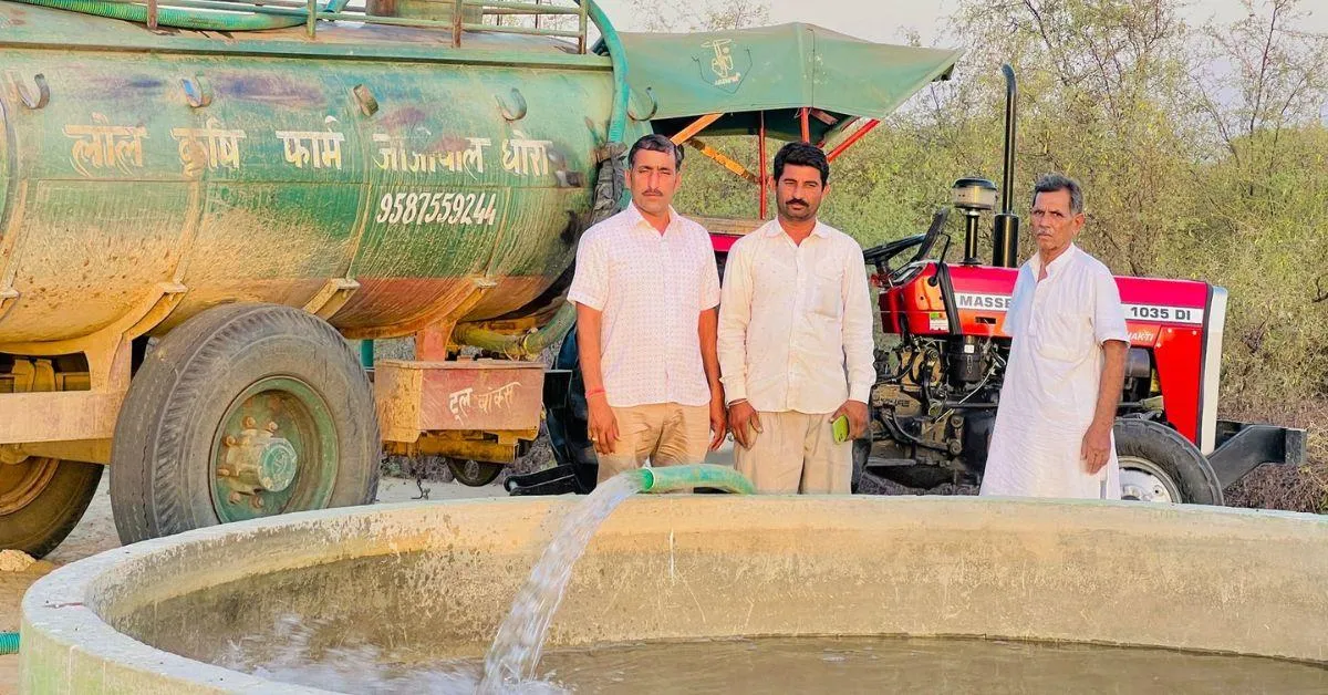team members in front of the water tank
