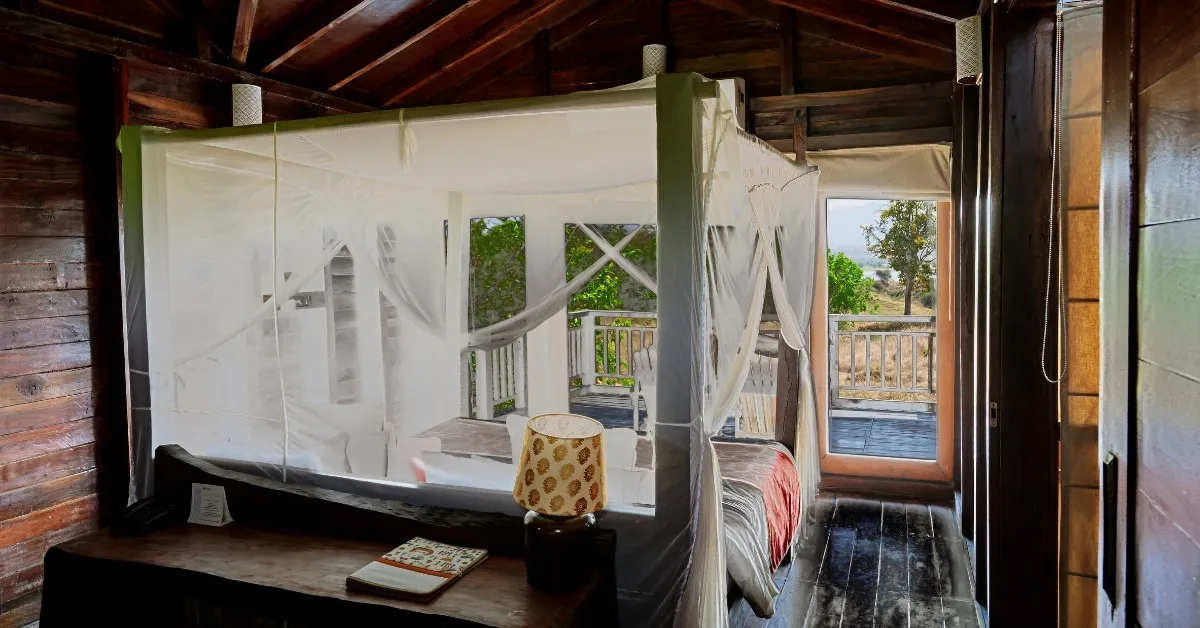 The treehouses at Denwa Backwater Escape offer elevated views of the Denwa River, blending comfort with natural immersion.