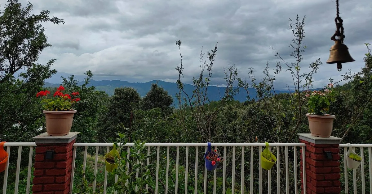 The view from their balcony includes the Nanda Devi range and Panchachuli peaks on a clear day.