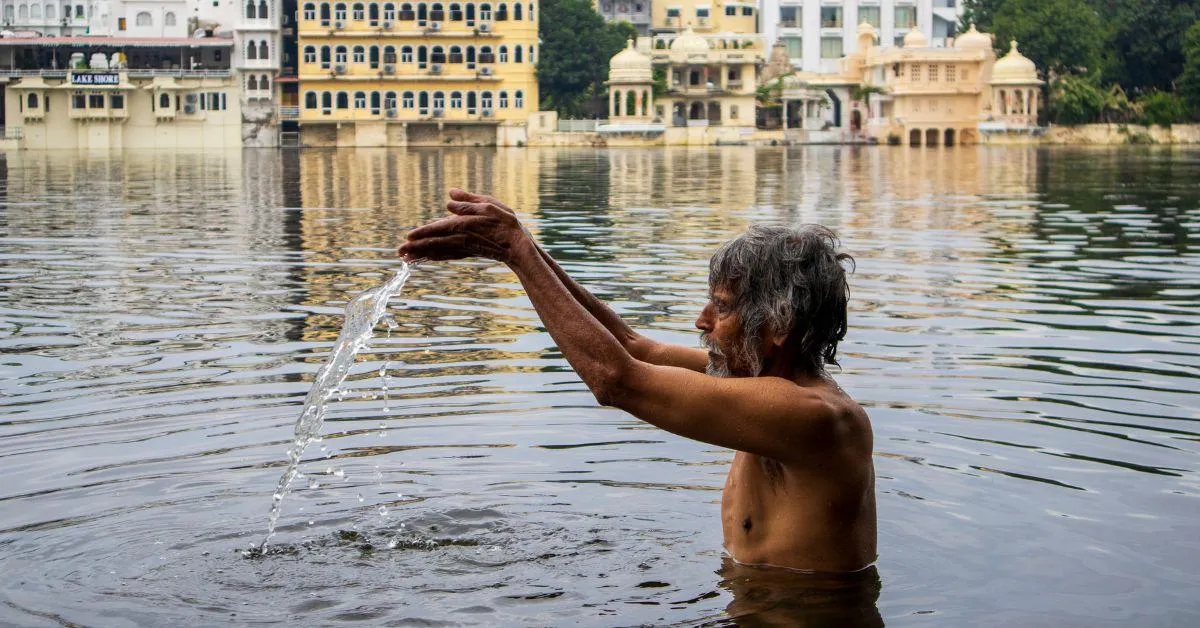 An elderly priest’s sunrise dip reflects Udaipur’s enduring spiritual bond with its lakes. 