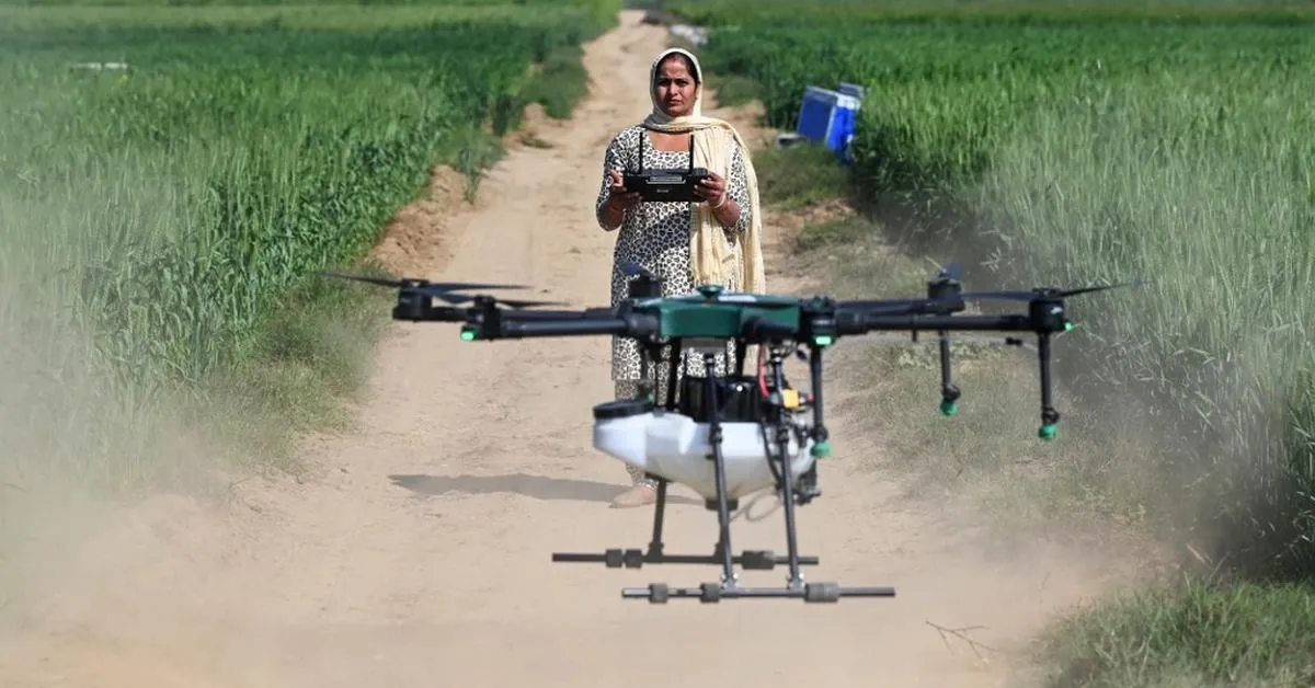 A single drone can spray 1 acre in just 7 minutes, drastically reducing labour time and chemical exposure for farmers. Picture source: AFP