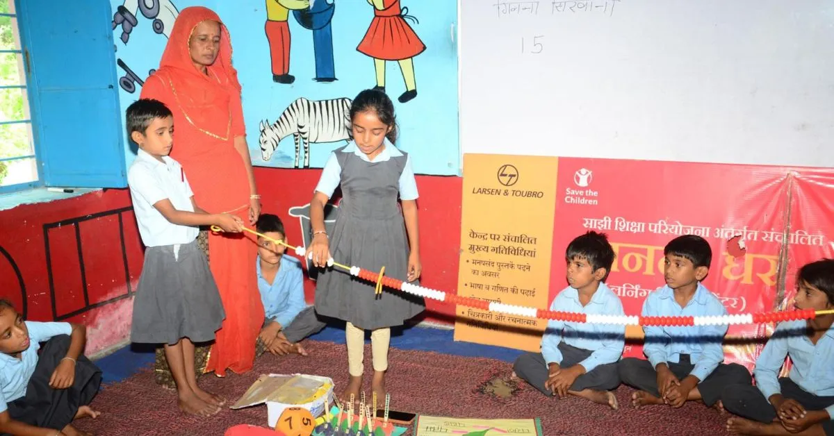 Local youth like Laxmi mentor school-age children in after-school learning sessions.