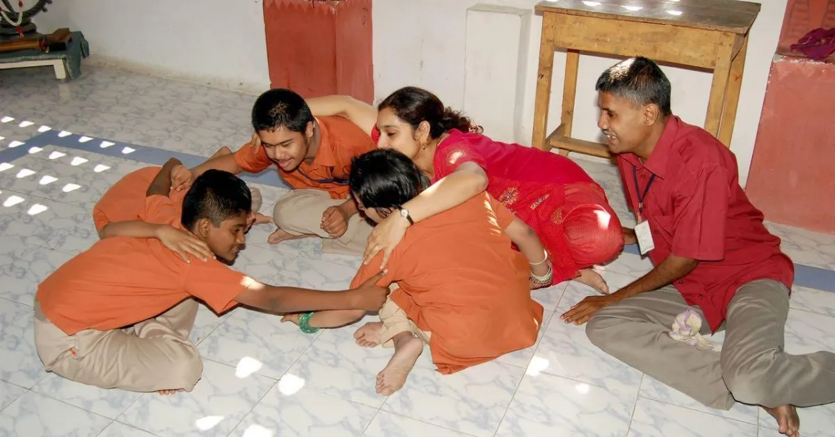 Ambika and children practising movements indoors