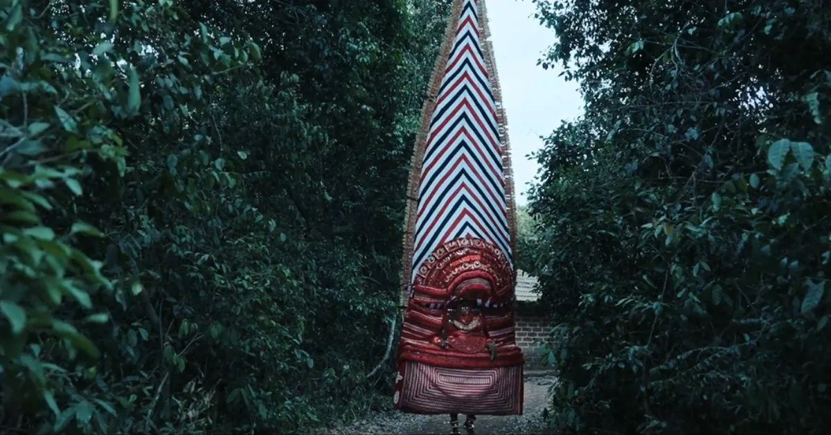 The 21-foot mudi (headdress) is placed atop the performer's head completing the costume 