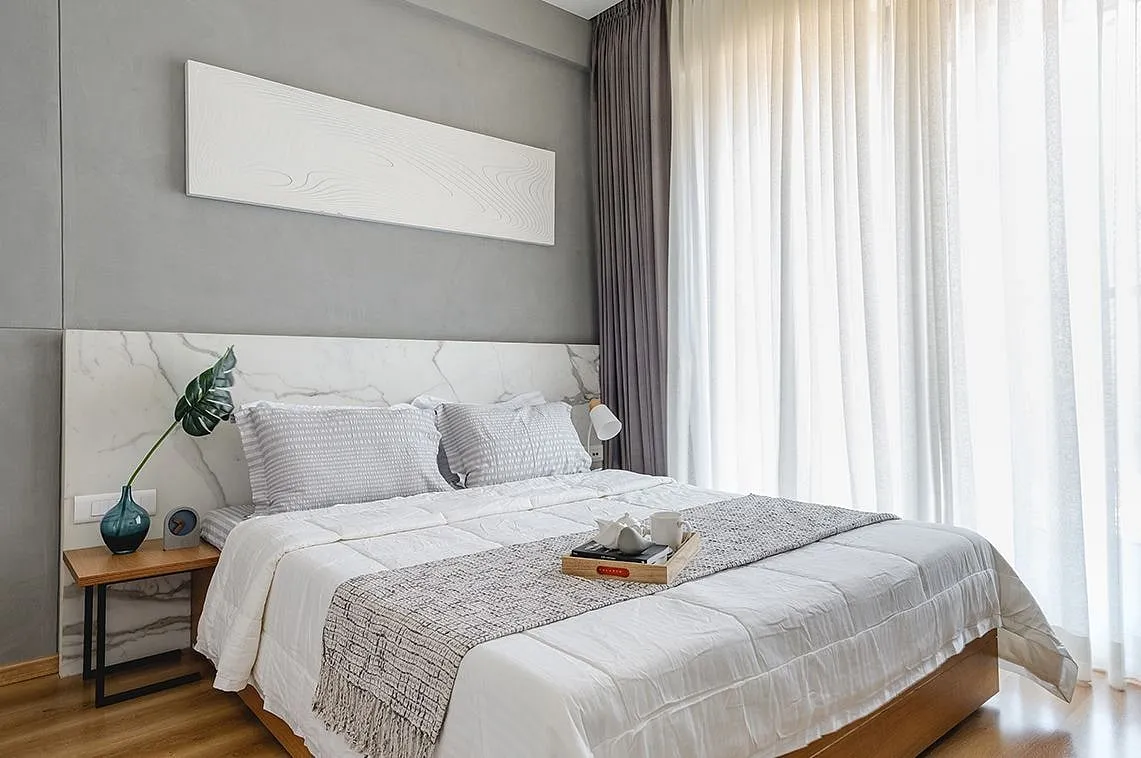 Metamorph-o-use by The BAD StudioA petite dining nook occupies a corner of the living room, asserting its own identity through a distinct wood-and-black palette. The master bedroom's headboard wall features statuario marble accentuating the room's luxe accents. The kid's room has a wall bed that folds up during the day. Folded up, the bed also hosts a pop-out table, instantly transforming the space into a library or study area. 