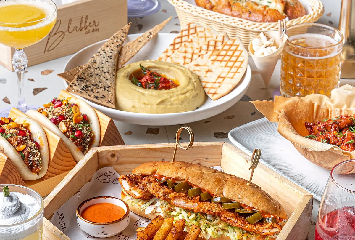 BlabberAn all-day dining bar, Blabber is located in Borivali East and is designed as a fuss-free space for long, intimate conversations with your loved ones. The food menu comprises offerings such as Korean Cheese Pull-Apart Bread, Tadka Hummus and Dabeli Bao, paired with cocktails like Garden in a Glass, Skinny Margarita and Popcorn Sour. The bar’s pink, floral upholstered seating, chandeliers and topiary from the ceiling can transport one to a vintage tea-party.Meal for two costs ₹1,500 approx. Signature cocktails are from ₹450. 