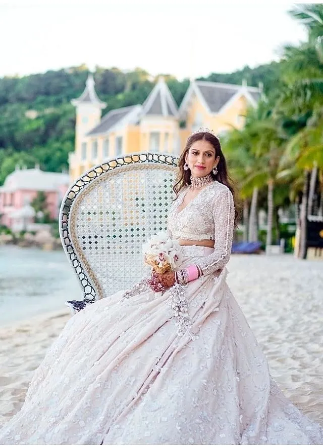 Kaabia Grewal's outfit featured a pastel shade of ecru in lace and appliqué work, with sprinkles of Swarovski and pearls 