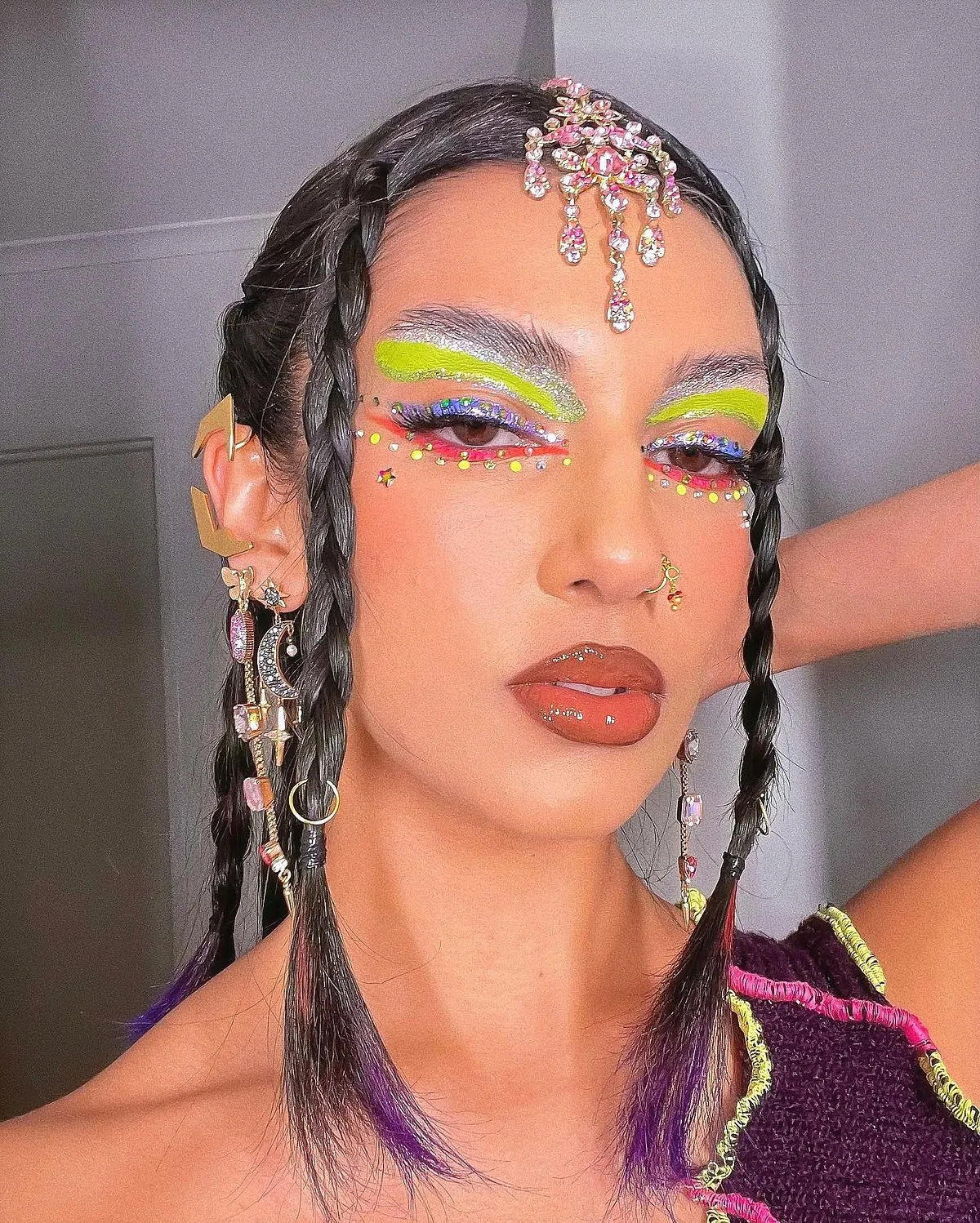 Rowi SinghYou might love Euphoria-style makeup—all those face gems and coloured eyeliner—but make-up artists like Rowi Singh have been popularising this maximalist style for years. She loves sparkly shadows, overly saturated colours and glossy lips, and she’ll find a way to add a gem or stud to her look to really shake things up. Come for the dramatic colours and popular reel music, stay for the way she intertwines her Indian culture through her work. Case in point: her recent orange jalebi-themed look. 