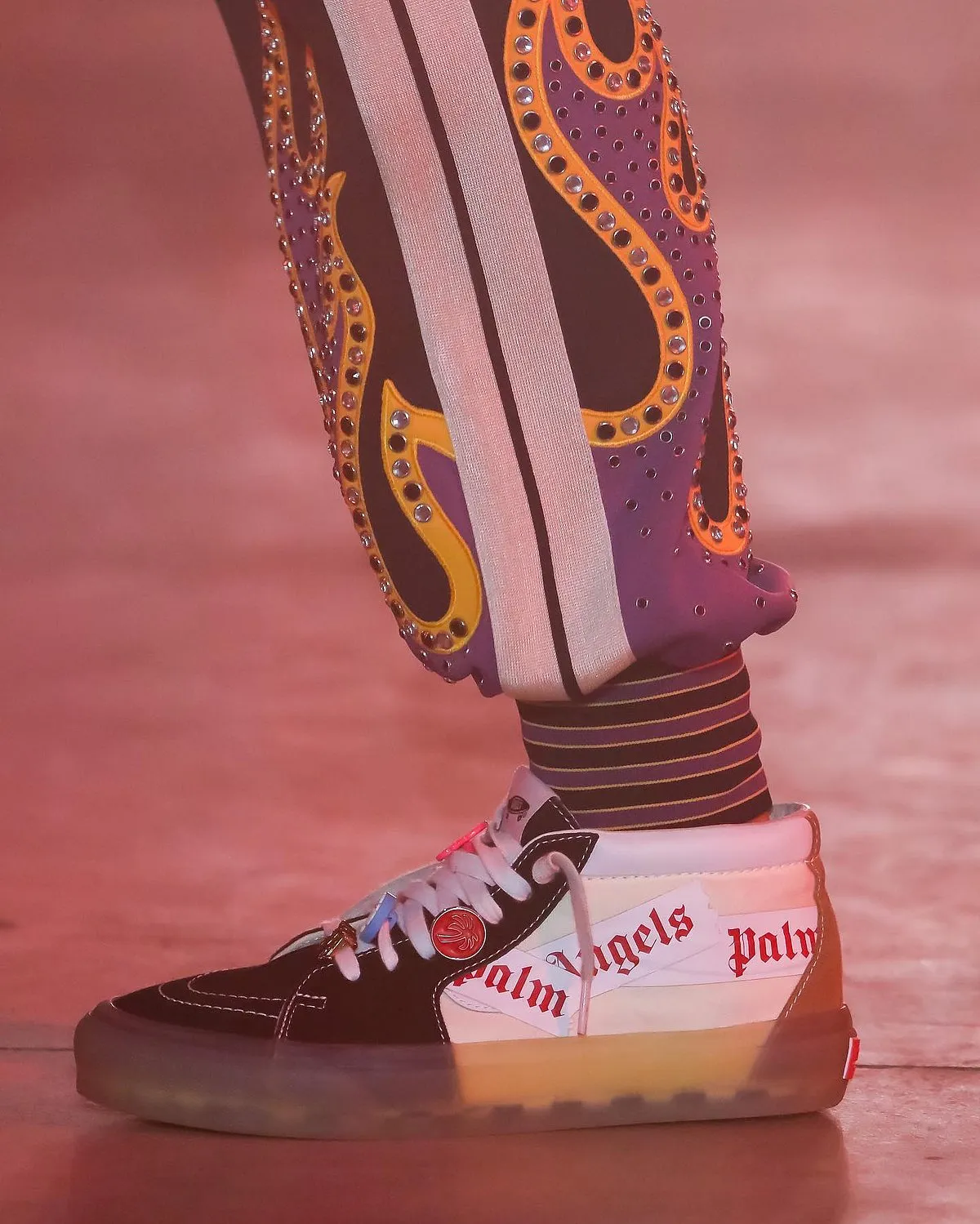 Palm Angels x Vans: Los Angeles-based luxury streetwear brand Palm Angels debuted their collaboration with Vans on the Fall/Winter 2022 runway. Palm Angels’ founder Francesco Ragazzi and Vans use the skateboarding brand's iconic high-top skate shoes from 1978, the Sk8-Hi (formerly known as Style 38) to mark their first-ever collaboration. The reimagined shoe, which boasts of a semi-translucent sole, uses Palm Angels’ brand tape to mimic Vans’ wave logo and is available in three colours of red, cream and brown. The shoes also feature a variety of metallic palm tree pins that decorate the flat laces along with a Vans skateboard motif tongue tab.Available on: Yet to be released 