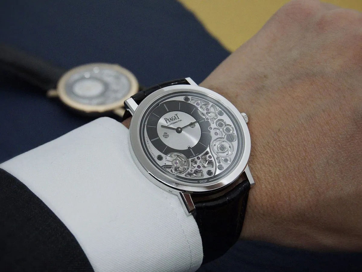 Piaget Altiplano Ultimate 910P Automatic:This is the thinnest watch Piaget makes, at just 4.3mm. It has an ultra-thin automatic movement, an 18k hand-polished rose gold or white gold case, an alligator leather strap with an 18k white/rose gold buckle and an incredibly tough sapphire crystal face–all this with 40-metre water-resistance. The skeleton dial has a glorious sunburst pattern that shines depending on the angle of the light. A true stunner. 
