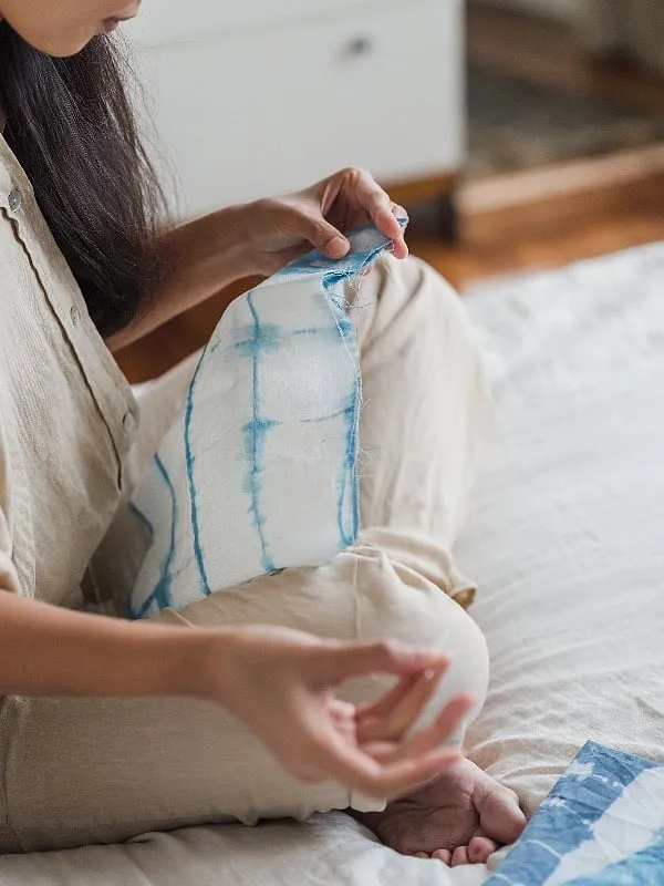 Sometimes, merely building on your belongings in their existing state like sewing a contrasting patch of fabric over a small stain. Image: Pexels 