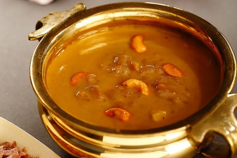 Ada Pradhaman is a dessert cooked with thick rice flakes, jaggery and coconut milk, simmered with dry ginger and cardamom. 