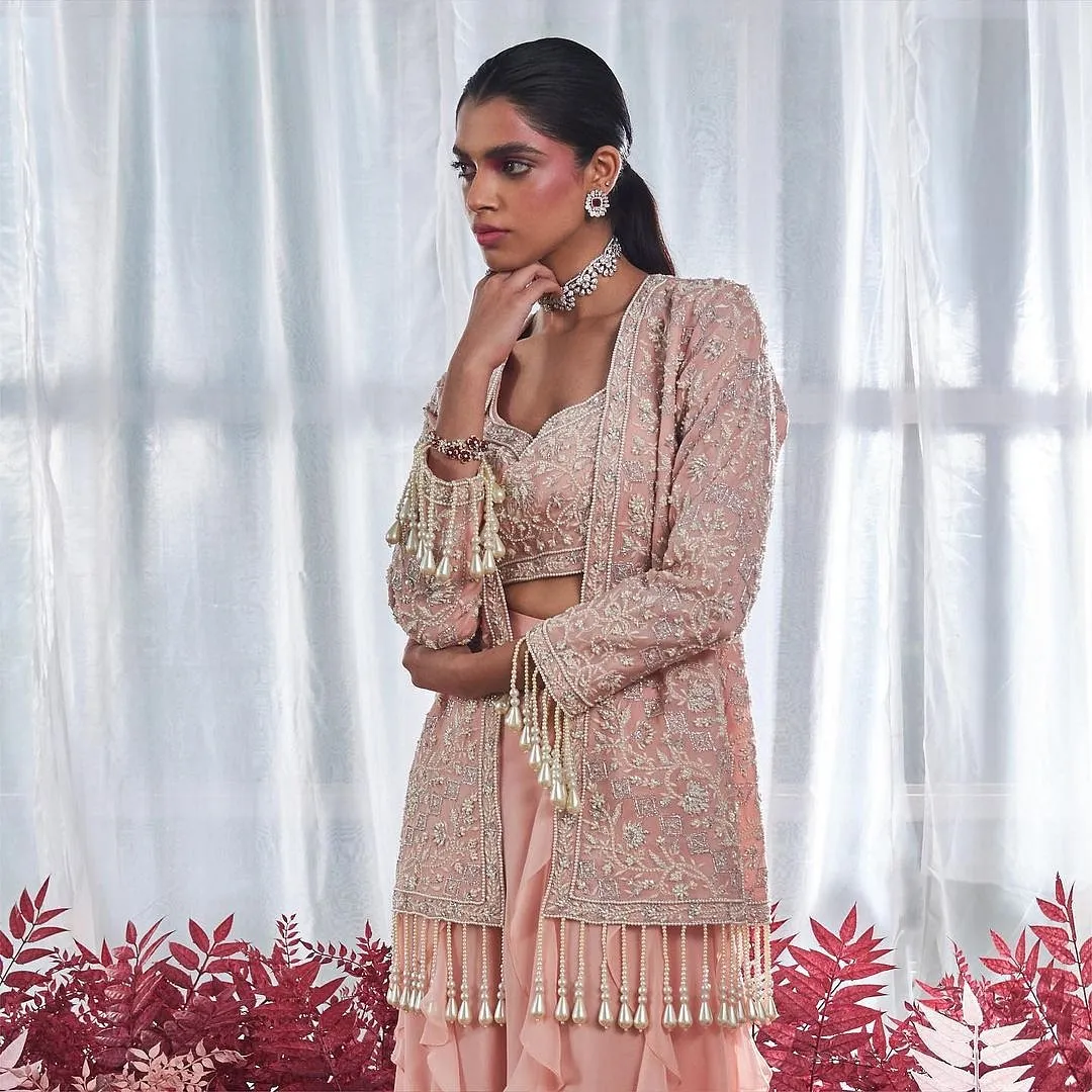 Devika BhayanaDesigner Devika Bhayana caters to those who are likely to attend an event with a “more is more” dress code this Diwali. Her latest line-up dials up the drama on staple silhouettes by adding frosty embroidery, ruffled dupattas and pearl tassels to the mix. Instagram.com/devikabhayanaofficial 