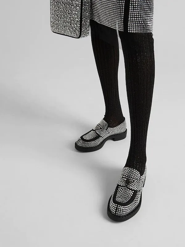 The Prada loafers are influencer-approved, chunky iteration that comes bearing a triangle plaque 