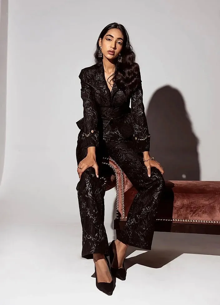 Lea Clothing Co's suits are in vibrant shades like sapphire and burgundy elevated  with pearls,  feathers and  boned corsetry 