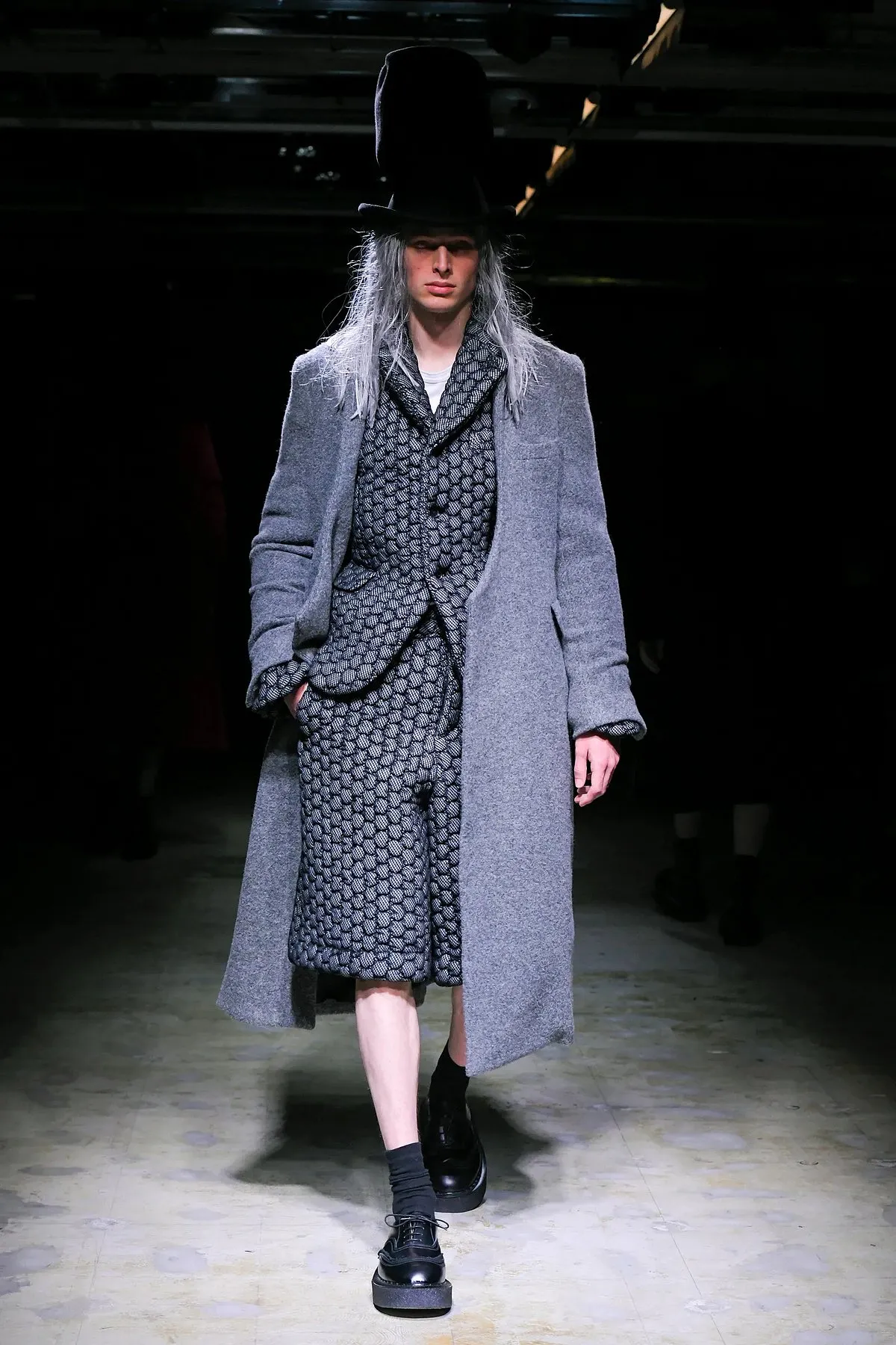 The closing look for Comme des Garçons was a tweed shorts suit paired with a heavy coat over it 