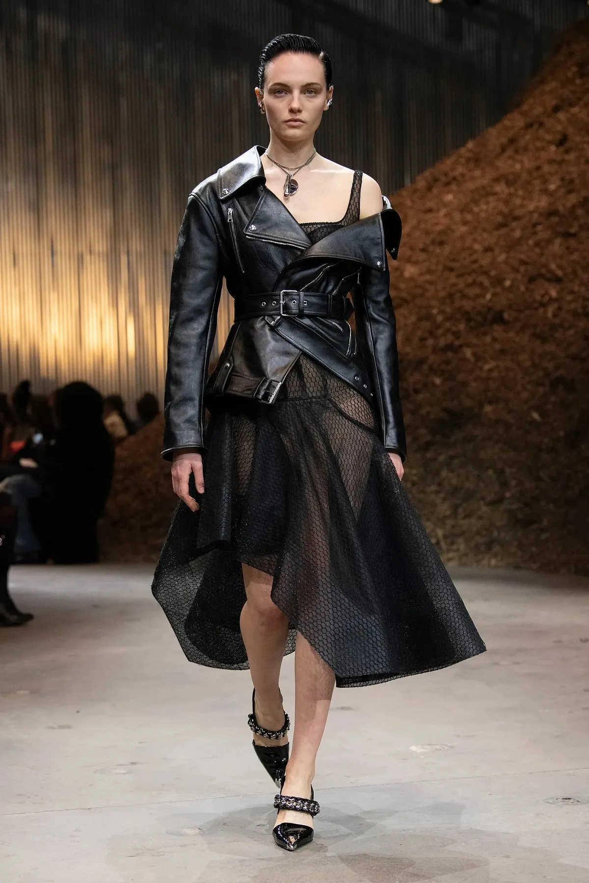Sarah Burton induced an element of punk with goth in a cropped biker jacket over sheer dresses and a leather jumpsuit with a corset as a bodice, for Alexander McQueen’s fall/winter collection 