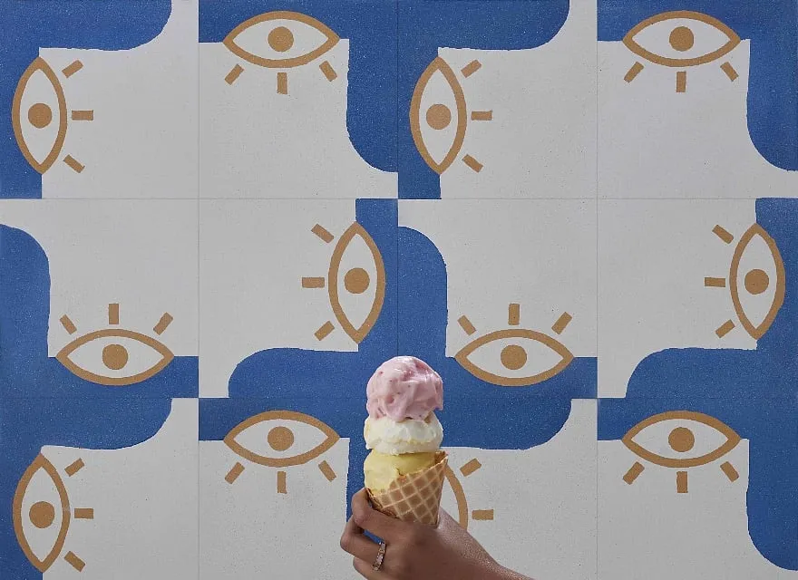 The geometric shapes of the traditional evil eye motif are reimagined as vibrant, almost fluid forms 