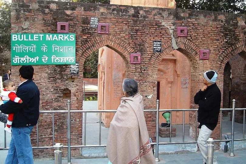 The walls at Jallianwala Bagh are splattered with bloodstains and riddled with bullet holes. Image: Britannica.com 