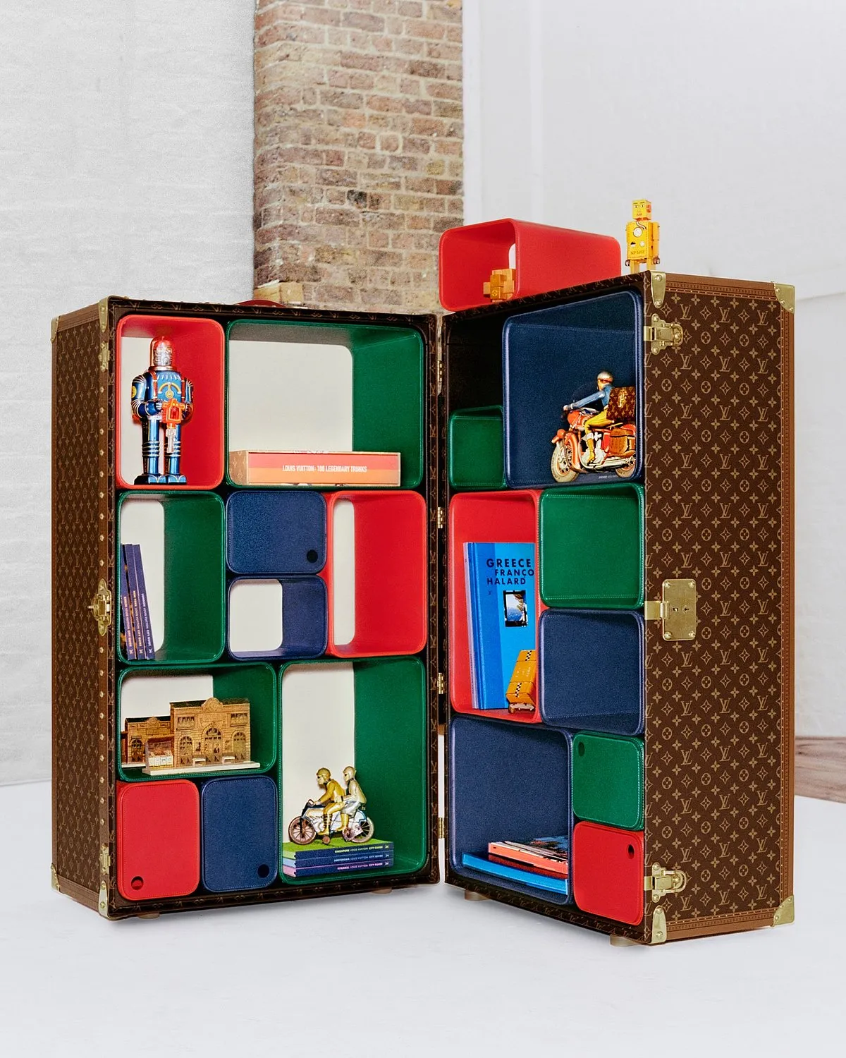 Louis Vuitton Cabinet of Curiosities by Marc NewsonLouis Vuitton's trunks were once used to carry travel essentials. Now, Marc Newson's limited 'Cabinet of Curiosities' (only 40 pieces) offers a dynamic canvas for personal display or storage. While it boasts the classic Vuitton monogram canvas outside, handcrafted cubes, configurable in over 1000 ways, some with hidden compartments, feature inside.  