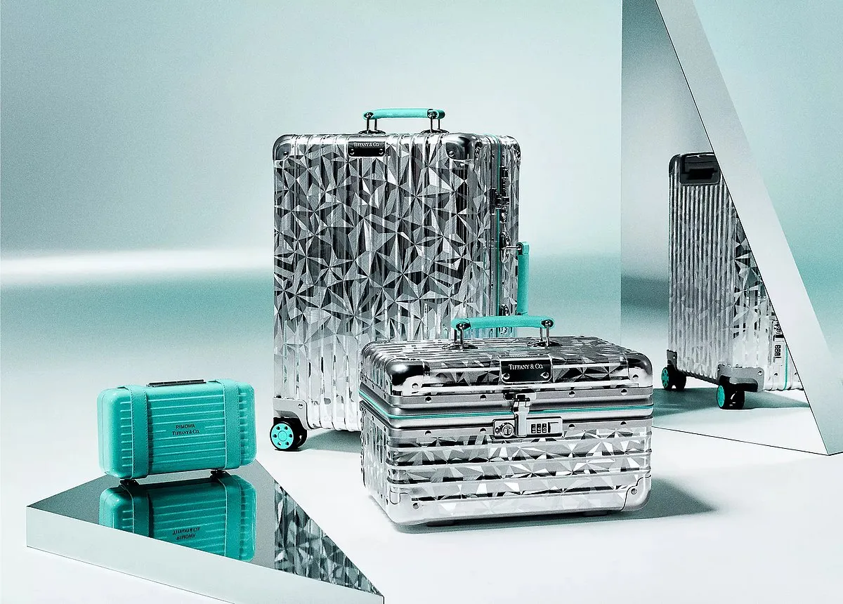 RIMOWA x Tiffany LuggageThe limited-edition capsule collection seamlessly blends the essence of two iconic brands. It achieves this by striking a harmonious balance between audacious, diamond-inspired design and unmatched materials.  