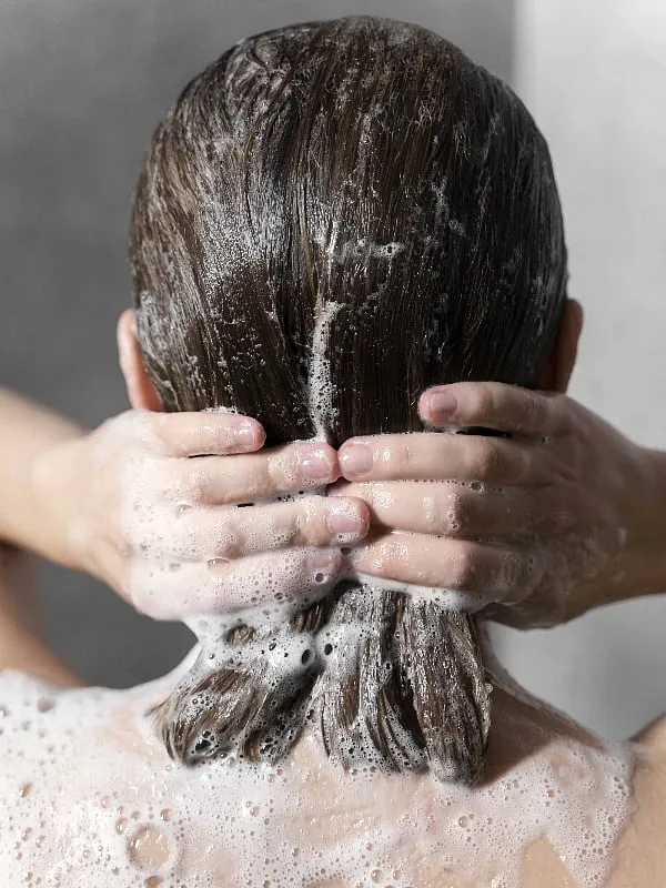 “Using a sulphate-free, pH-balanced shampoo and getting your hair trimmed every 6-8 weeks are habits that benefit every hair type,” advises Rod Anker. Image: Pexels 