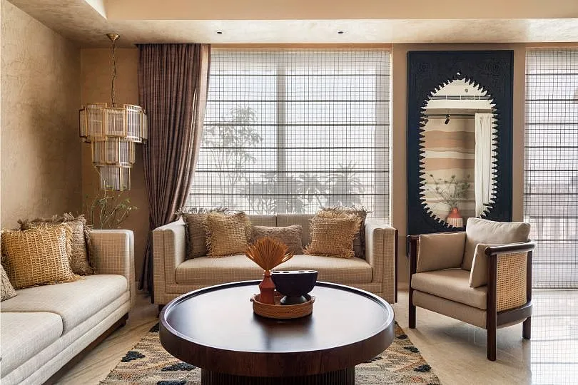 Upon stepping into the living room, especially in the daytime, you notice how the natural light exaggerates the textures of the lime-washed walls that are offset by the wicker-detailed sofa and accompanying chairs. Image: Avesh Gaur 