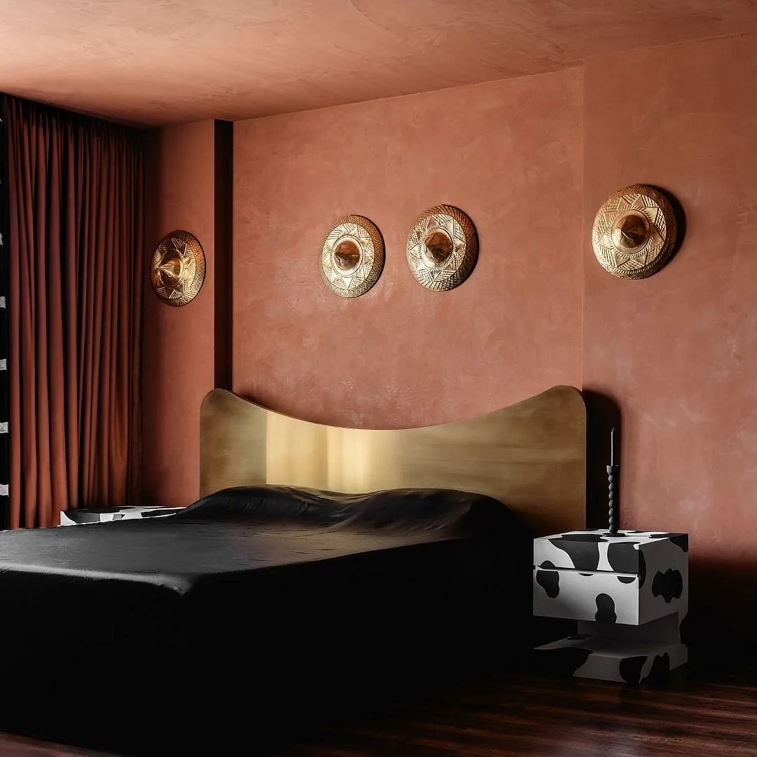 The hand beaten brass artwork above the master bed is  the 