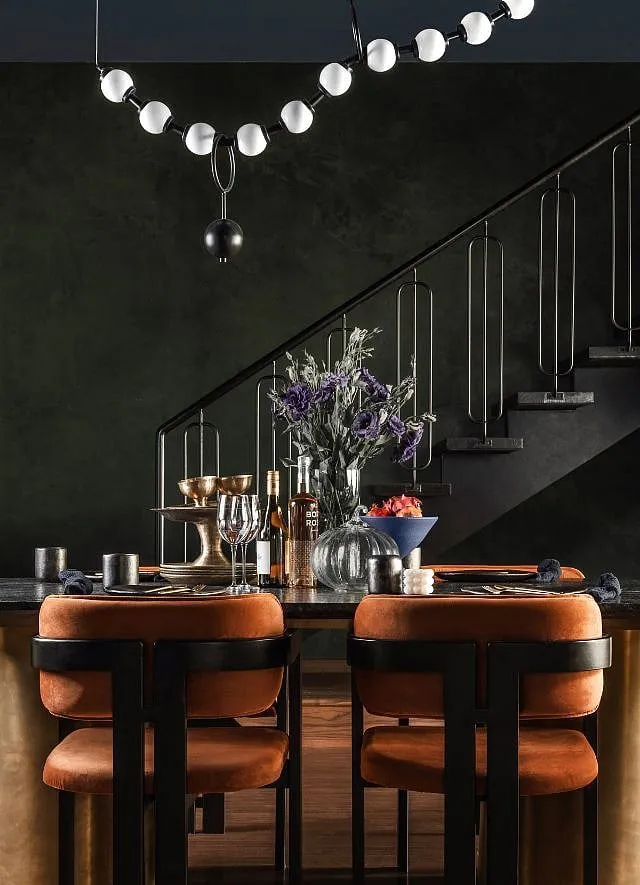 Solid, natural, unpolished black marble stone sourced from Rajasthan constitutes the top of the dining table designed by Humming Tree, and executed by Soffit 