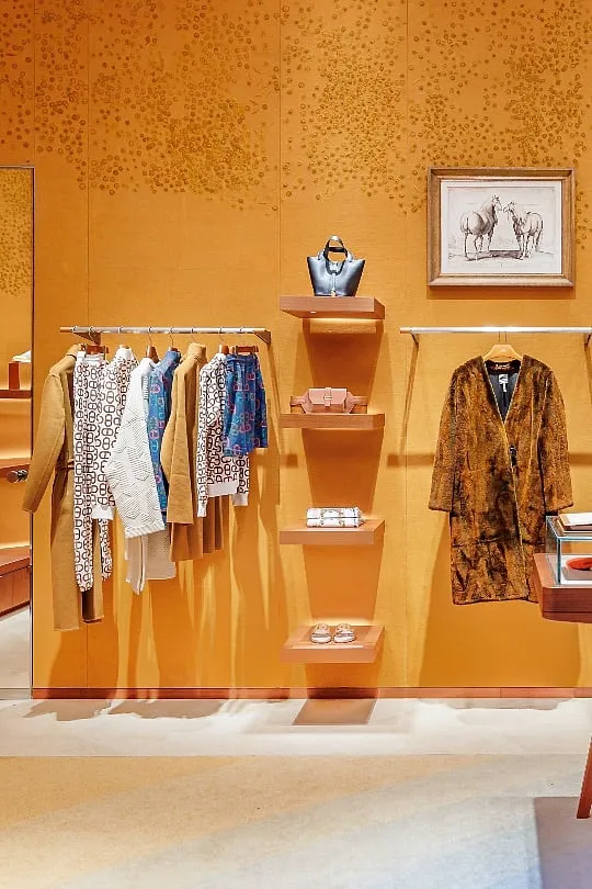The men’s and women’s ready-to-wear sections feature fabric-covered walls, hand-embroidered by a local atelier in a turmeric-coloured motif reminiscent of the shadow-dotted streets of the city. Image: Six Ways to Sunday 