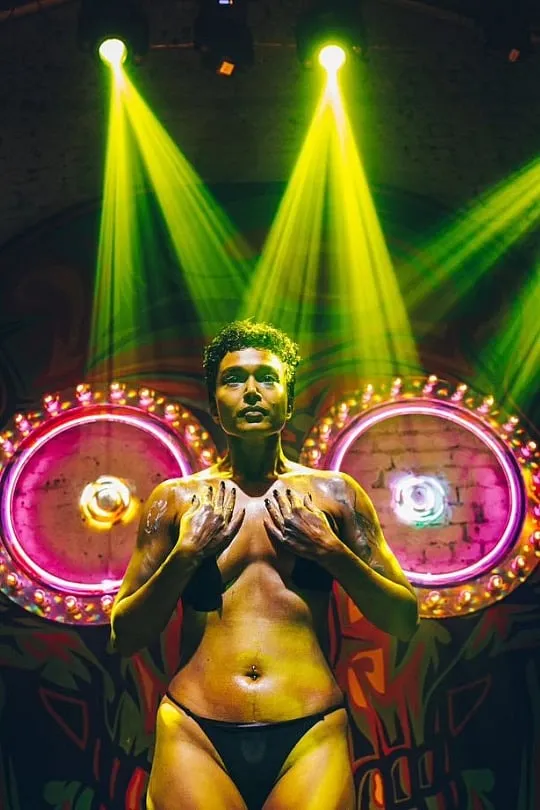 Durga Gawde in their drag king persona on stage. Image: Instagram.com/durgagawdestudio. Photographer: Shreya Shetty 