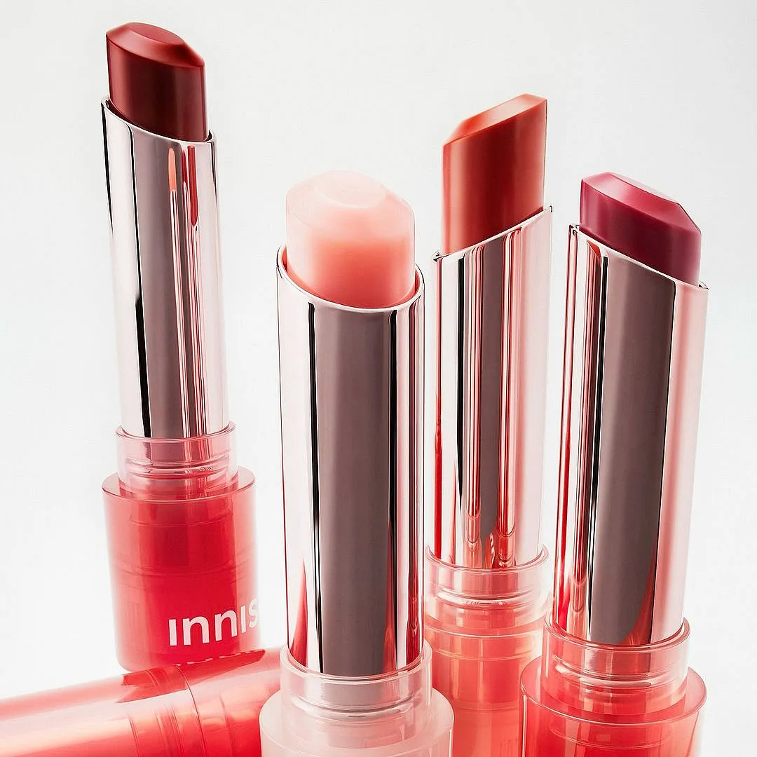 Dewy Tint Lip Balm, InnisfreeThe newest tinted lip balms from Innisfree could replace your sheer lipsticks. Hydrators like hyaluronic acid, ceramides, camellia oil, glycerin, and murumuru seed butter allow this lip balm to perform like a treatment for chapped, cracked, and dry lips. From a terracotta nude to a pink, red and plum colour, this moisturising lip balm is available in fun, poppy hues for every mood of the week.Image: Instagram.com/innisfreeindia 4 opened tubes of tinted lip balms by Innisfree in red, pink, nude, and plum, indicating how similar they are to lipsticks