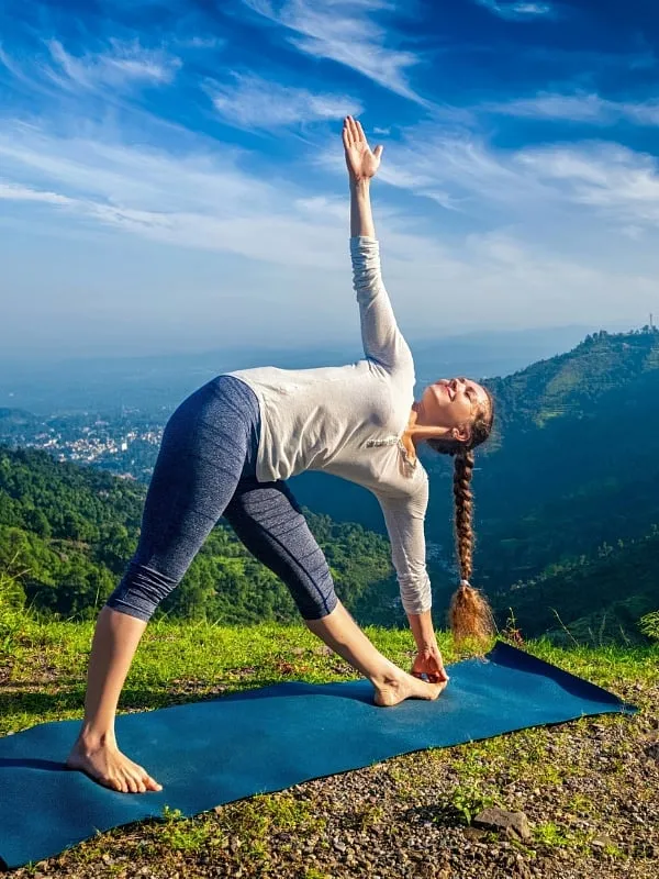 Mastering the Triangle Pose, which is a part of Hatha yoga, will help with stiff legs and hips. Image: Unsplash 
