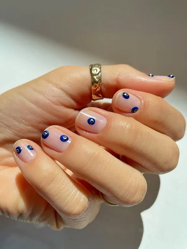 The evil eye design is one way to create the 'barely-there dot' nail art. Image: Instagram.com/betina_goldstein 
