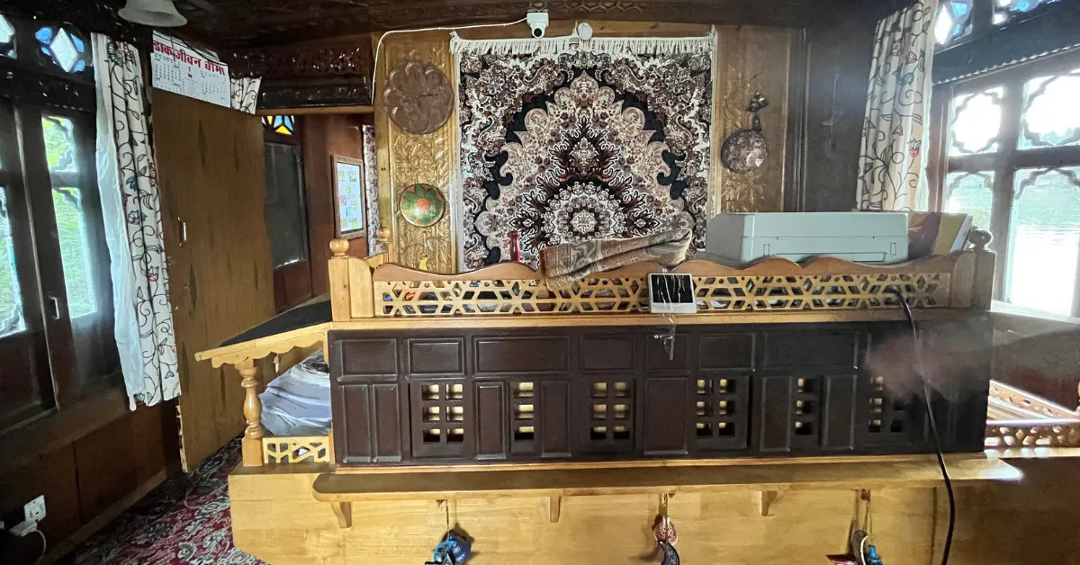 Inside the houseboat, the post office counter blends function with Kashmiri design and craftsmanship.