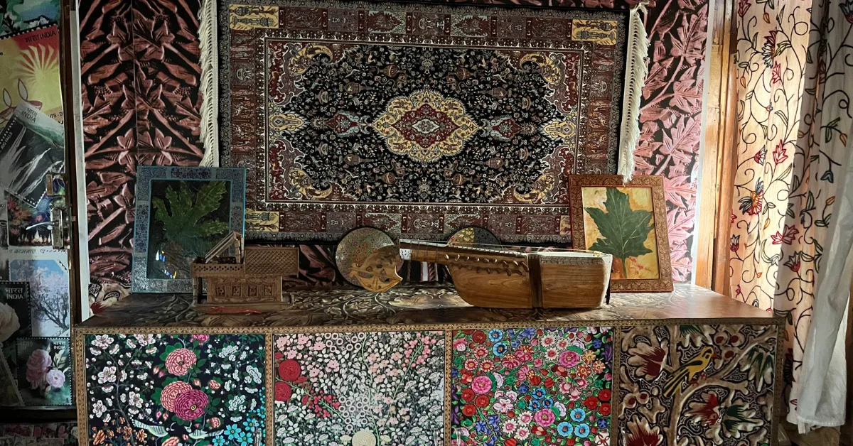 Rich carpets and carved walnut panels turn the floating post office into a living gallery of Kashmiri heritage.