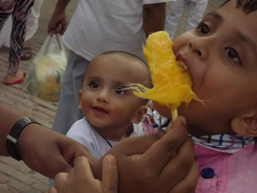 A child enjoying ice fruit mango