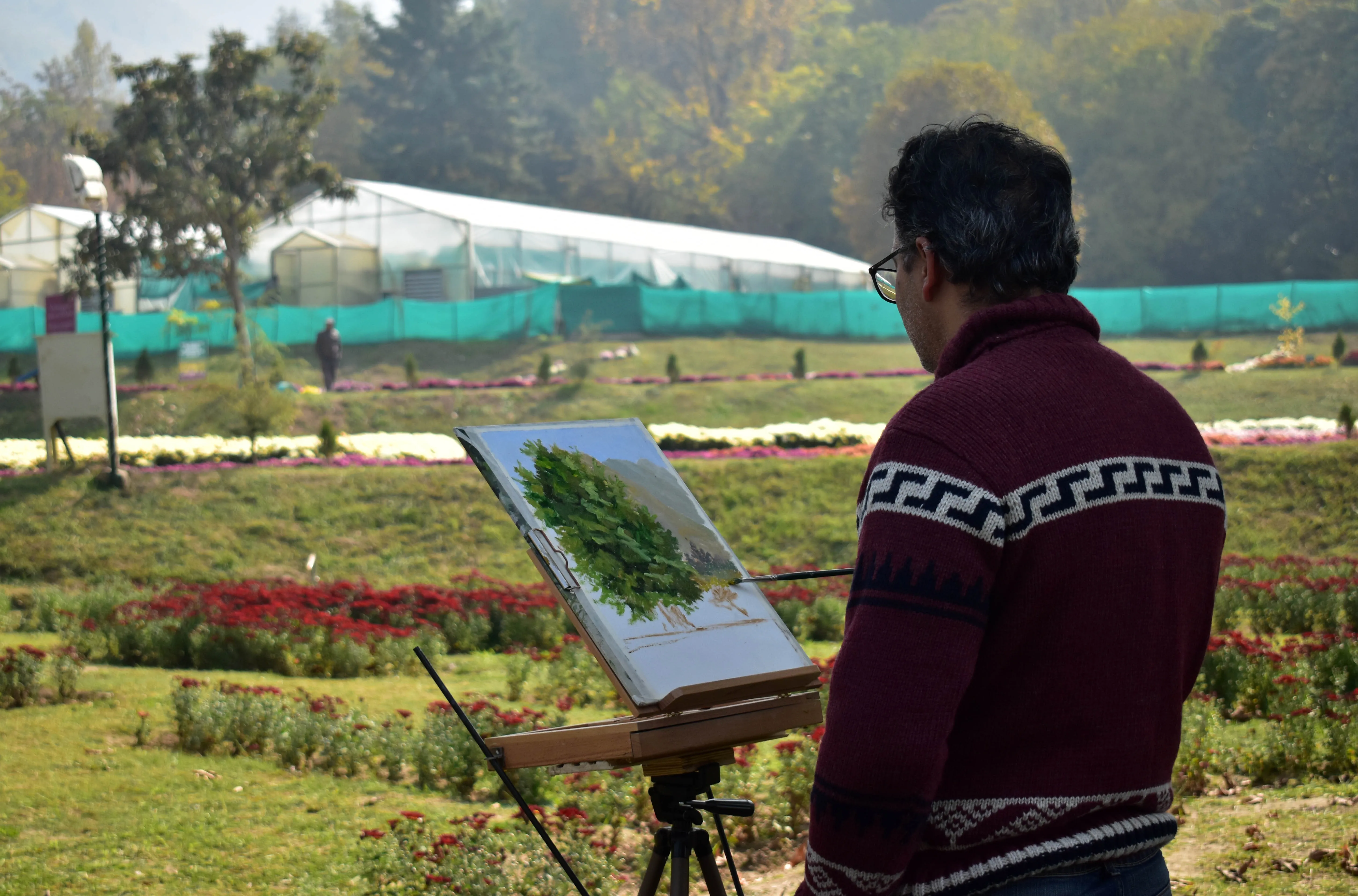 An artist captures the garden’s natural scenery on his canvas at Bagh-e-Gul-e-Dawood, Srinagar.