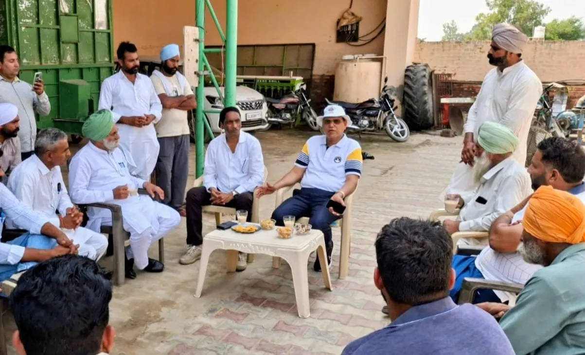 Dr Singh (seated in the centre) interacting with rice farmers