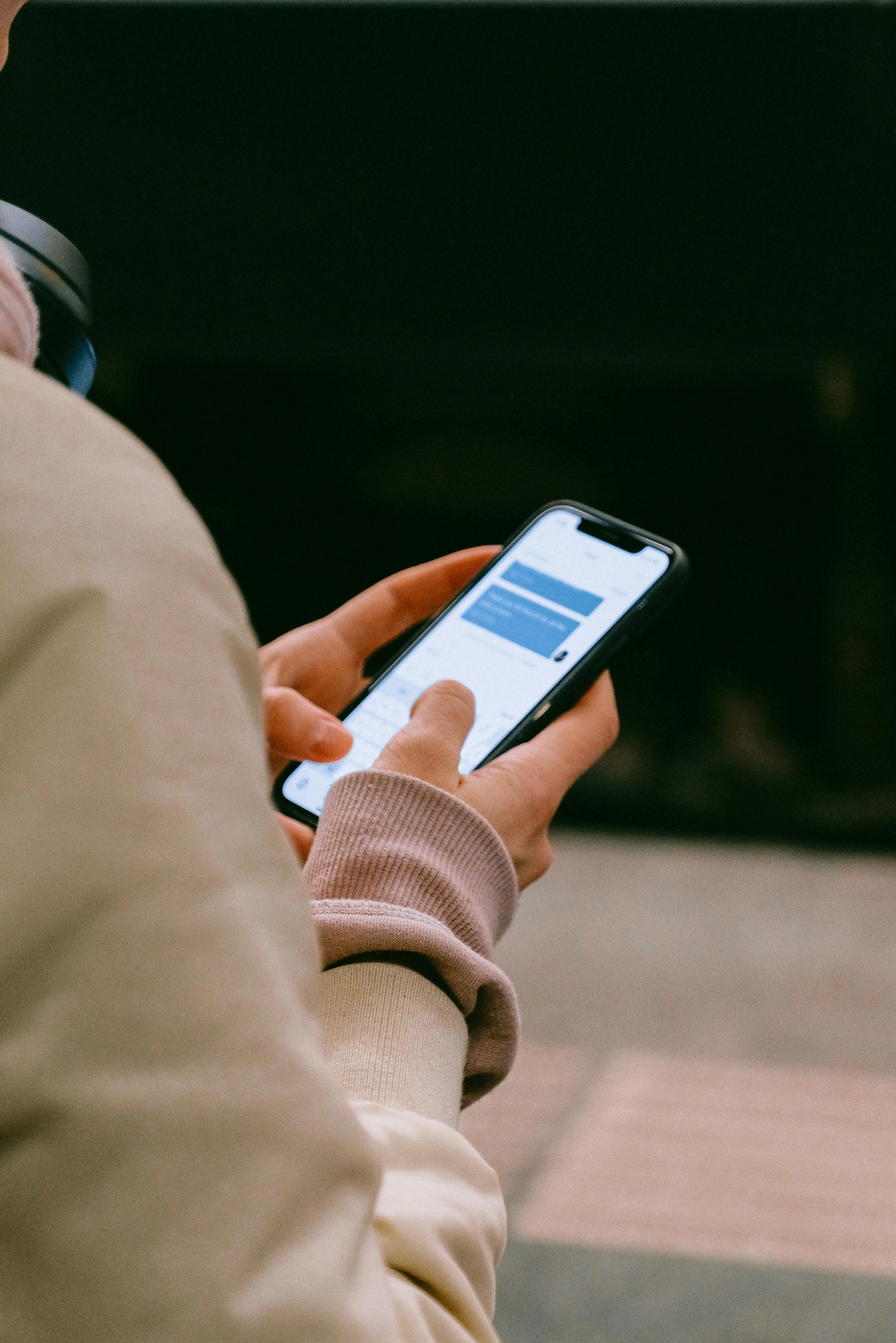 A picture of a person texting on their phone