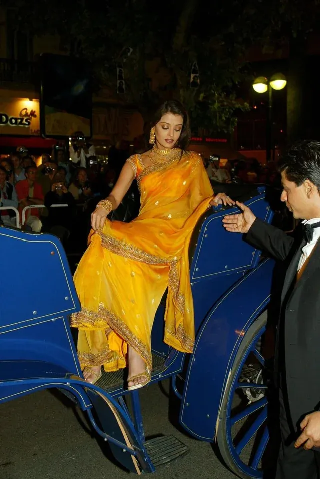 Aishwarya Rai Bachchan making her Cannes debut in 2002, wearing a yellow Neeta Lulla sari, marking a pivotal Indian red carpet fashion moment