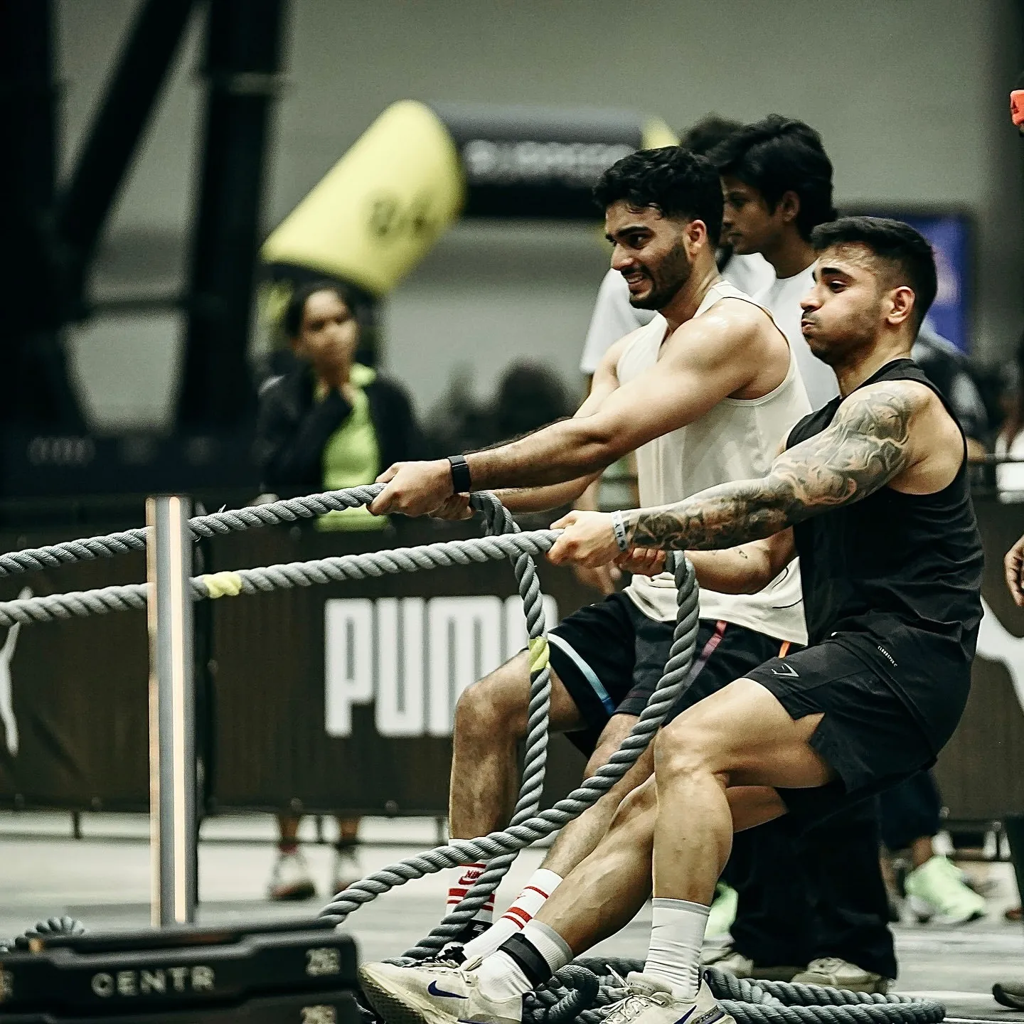 Participants at Hyrox India compete in a sled push challenge during a functional fitness race in Mumbai