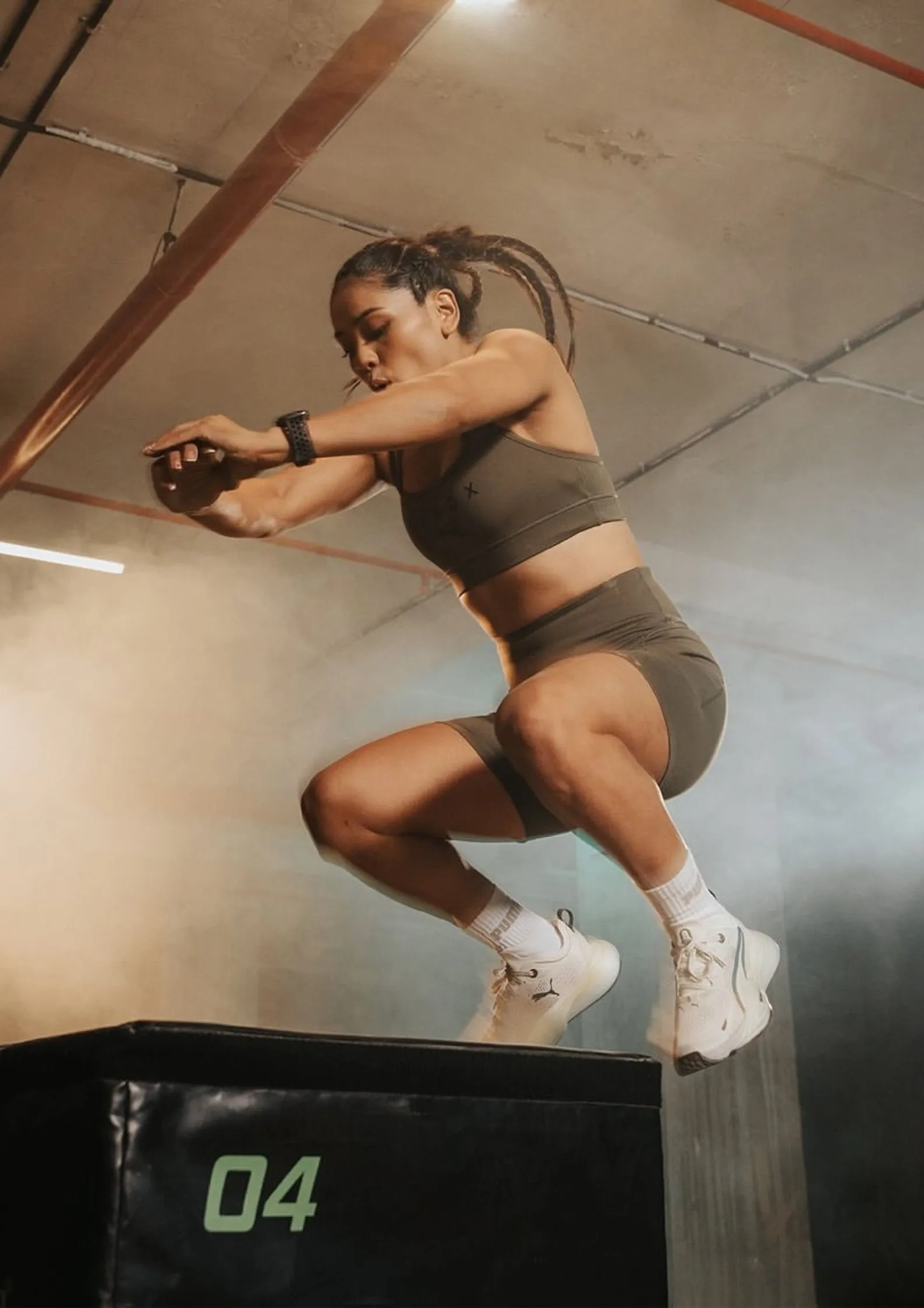 Woman athlete performing a box jump during a functional fitness workout, representing Hyrox India’s focus on strength and endurance.
