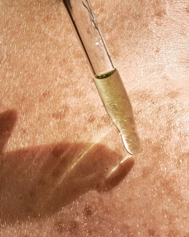 A pipette closer to the skin to apply hydrating serum on sensitive skin